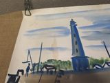 a picture of a painting of a lighthouse on a table