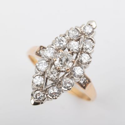 a close up of a diamond ring on a white surface