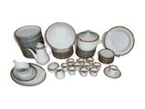 a picture of a group of white and gold dishes and cups