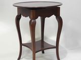 a wooden table with a round top and a wooden base