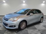 a silver citrole parked on a checkered floor in a garage