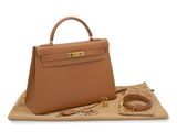 a brown leather handbag sitting on top of a tan blanket