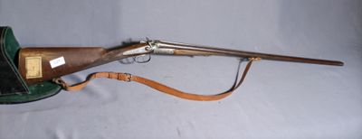 an old rifle with a leather case sitting on a white surface