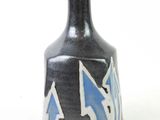 a black vase with a blue and white design on it