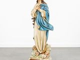 the statue of jesus is standing on a rock in a room