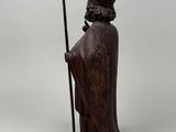 an image of a statue of a man holding a staff