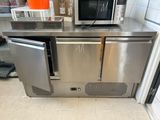a microwave sitting on top of a stainless steel counter