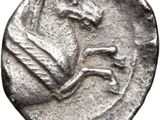 a silver coin with a horse on it ' s head