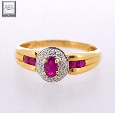 an image of a gold ring with a ruby and diamond center