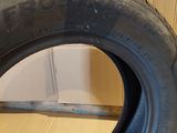 a close up of a tire on a wooden floor next to a wall