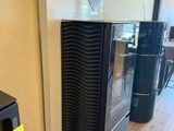 a black stove sitting in a room with a sign on the wall