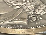 a silver coin with a picture of a woman on it