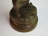 a bronze statue of a cat on a pedestal