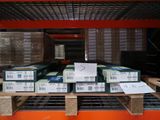 many boxes that are on a pallet in the warehouse