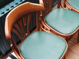 four chairs that are lined up on a wooden floor