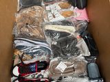 a cardboard box filled with many pairs of shoes