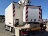 a white truck with a crane on the back of it