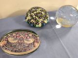 trois récipients en verre posés sur une table à côté d'une boule en verre
