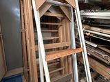a pile of wood in a room with many different types of wood
