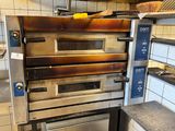 an oven that is sitting in the middle of a kitchen
