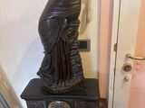 a statue of a woman sitting on top of a table