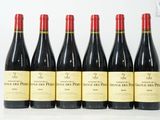 six bouteilles de vin rouge sont alignées sur une surface blanche
