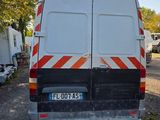 a van that is parked in a lot with other vehicles