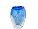 a blue glass vase with bubbles in it on a white background