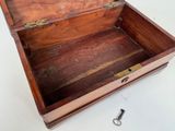 a wooden box with a key in it on a table