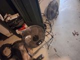 a fan that is sitting on the floor next to a fan