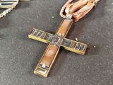 a cross that is sitting on a table next to other items