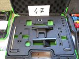 a black case with a green handle and some tools in it