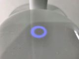 a close up of a blue ring on the top of a faucet