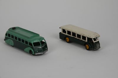 two toy buses sitting next to each other on a white surface