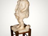 an image of a small statue of a child on a stool
