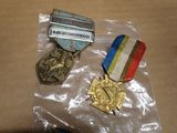 three medals on a plastic bag on a table