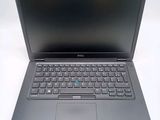 the dell laptop is open and ready to be used on the desk