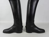 pair of black leather riding boots with wooden soles on a white background