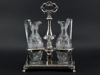 two crystal vases sitting on a silver stand