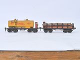 two toy trains that are sitting on a wooden table