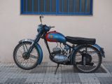 a blue and red motorcycle parked on the side of the street