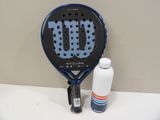 a tennis racket with a bottle of water next to it