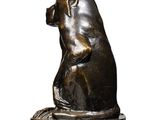 bronze sculpture of a bear sitting on a rock on a white background