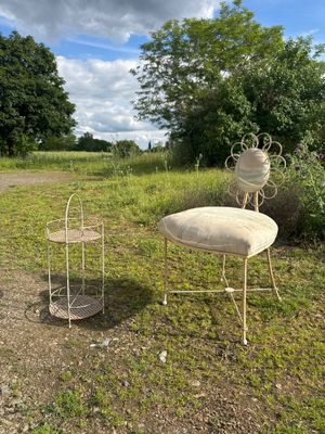 two chairs and a table in the middle of a field