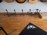 guitars hanging on a wall in a music studio