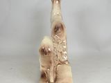 a figurine of a giraffe sitting on top of a wooden block