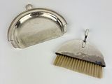 two silverware items including a brush and a silver plate