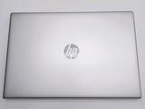 the back of a laptop computer sitting on top of a white table