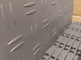 a close up of a metal bench in a room
