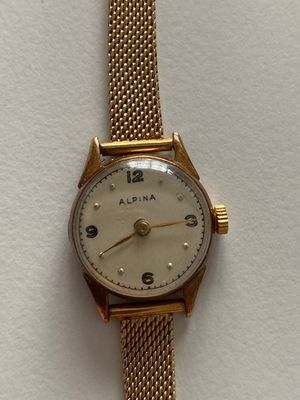 a close up of a wrist watch on a white surface